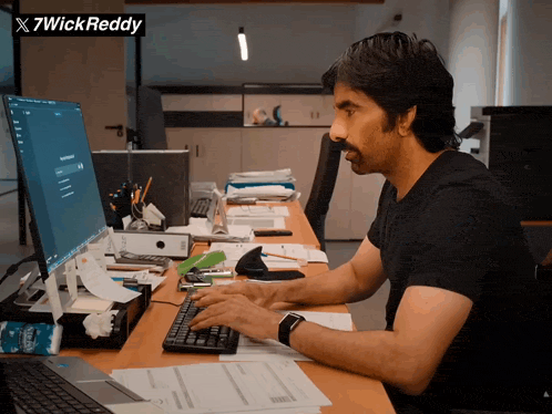 Person working hard at a computer managing an advertising campaign