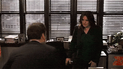 Two people sitting across from each other in a business meeting